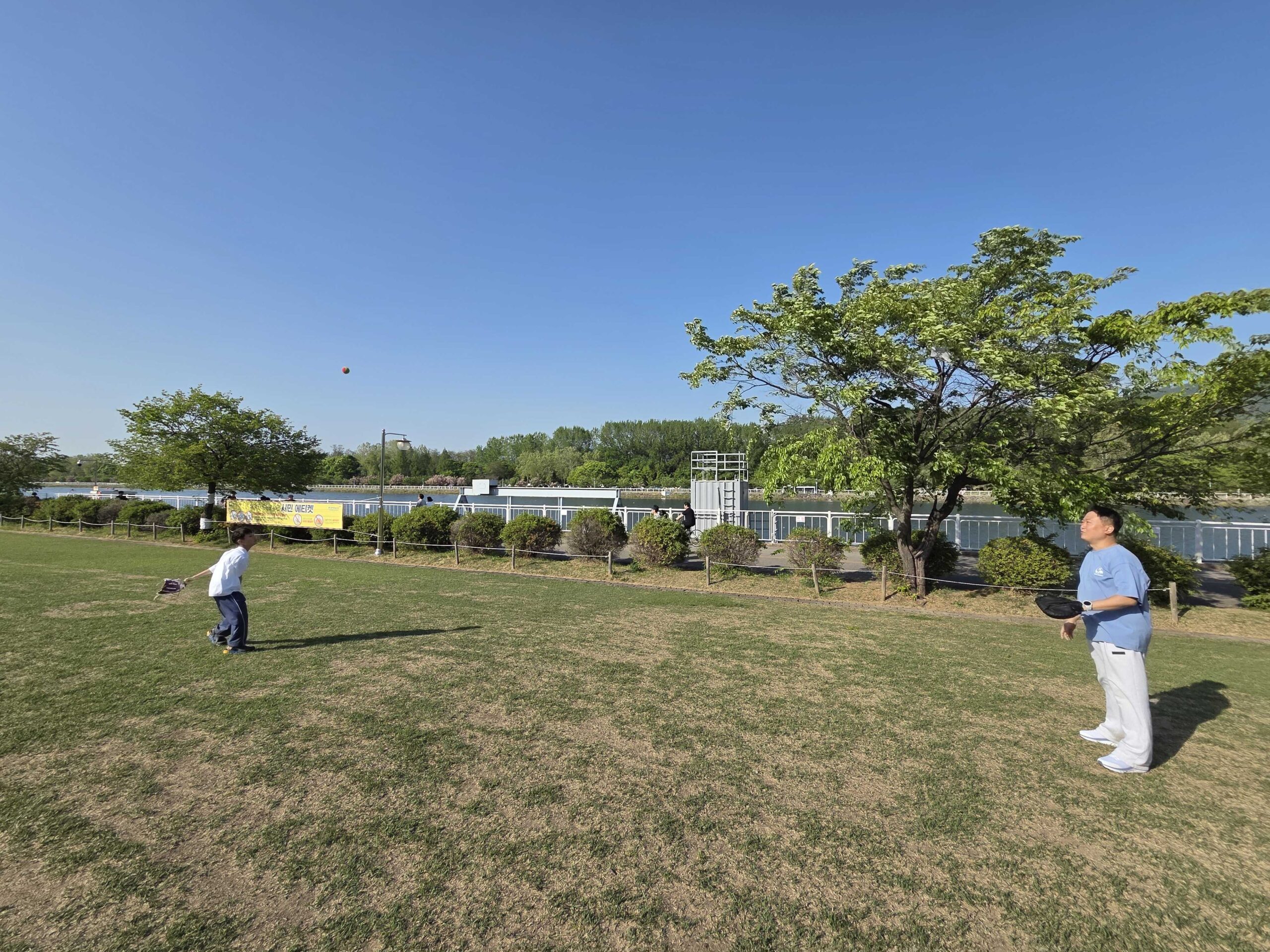 Misari Park Hanam catch on the riverside lawn with the Han River and mountains behind