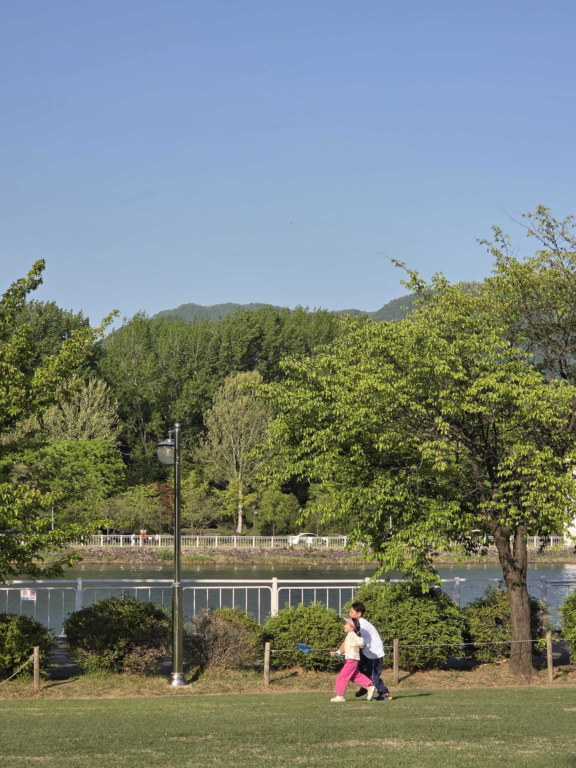 Misari Park Hanam riverside walking path with mountains and the Han River in the background