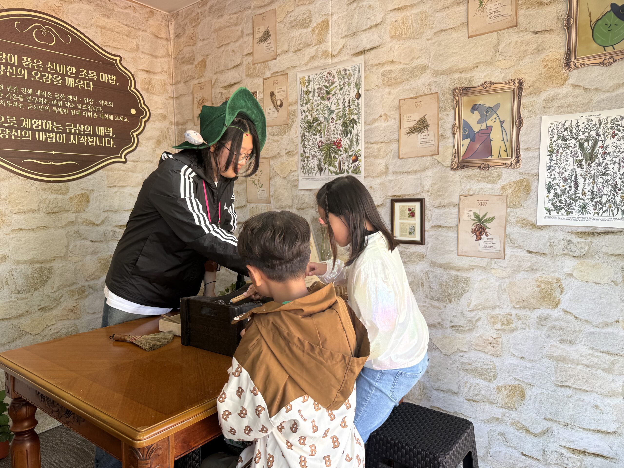 Hands-on experience zone with staff helping kids at Taean Horticultural Therapy Expo