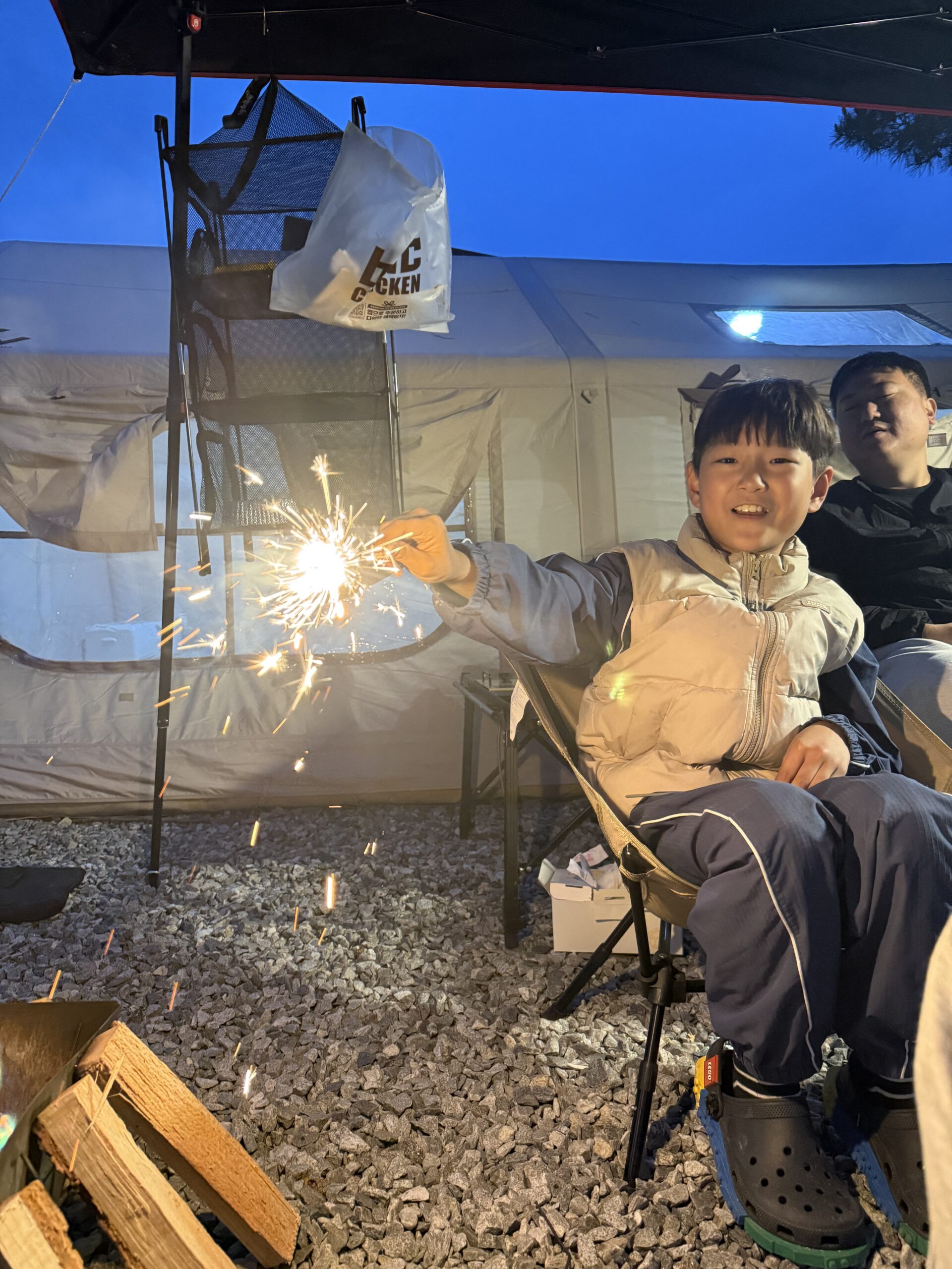 Rainbow magic flame at Naepo Camping Square bonfire with blue green and orange colors