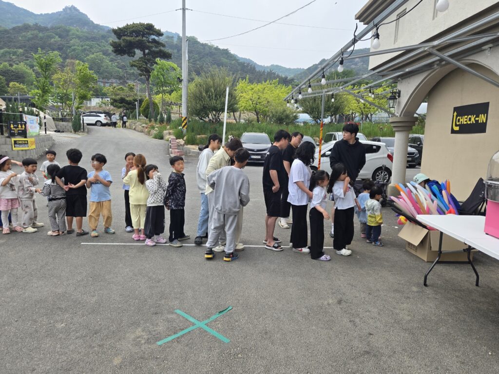 Naepo Camping Square check-in area with kids gathering for Children's Day activities