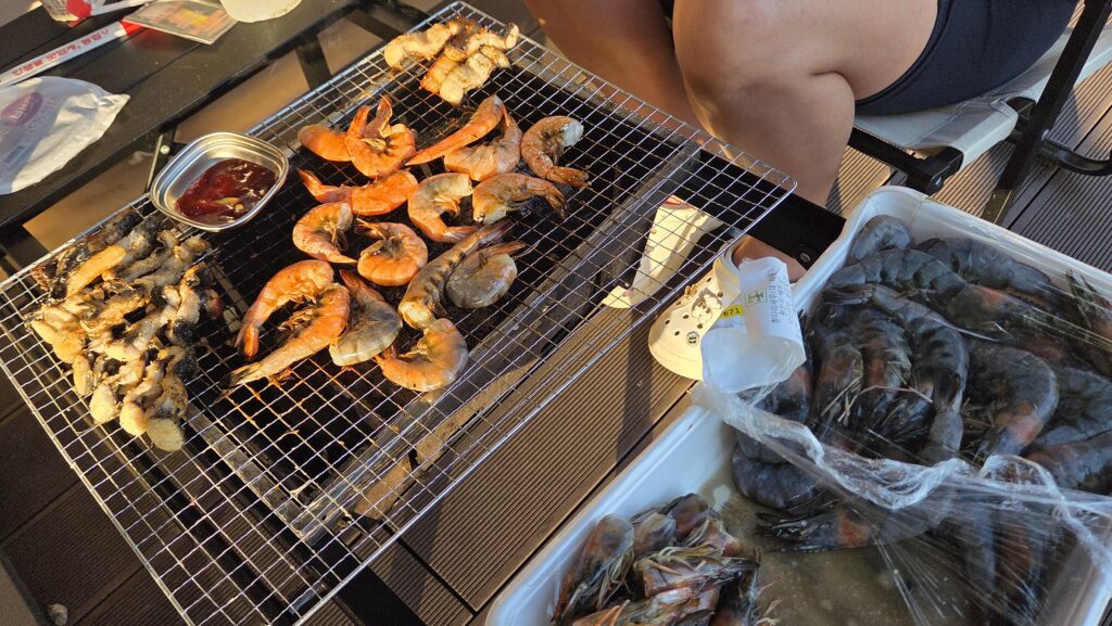 Shrimp grilling over charcoal at our Choihu Camping Hanam dinner