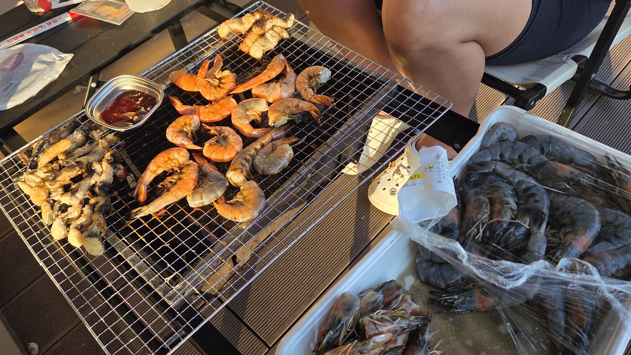 Shrimp grilling over charcoal at our Choihu Camping Hanam dinner