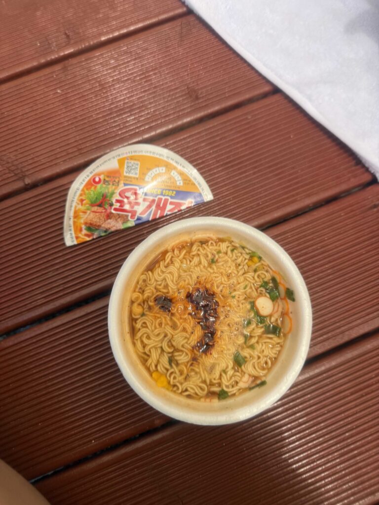 Cup ramen on a rented wooden platform at Jangho Beach with kids in Samcheok