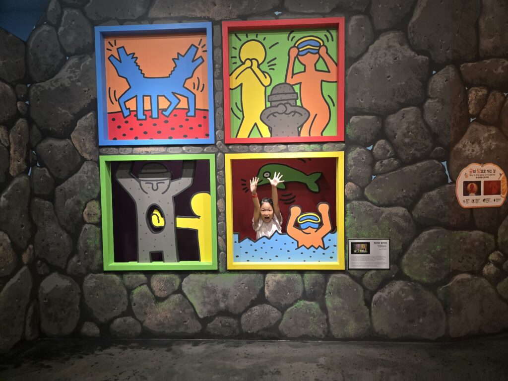 Child in a pop-art frame illusion at the Jeju trick art museum