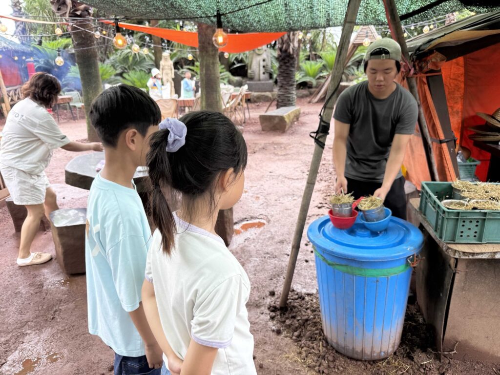 Getting a bowl of animal feed at Little Prince Tangerine Farm