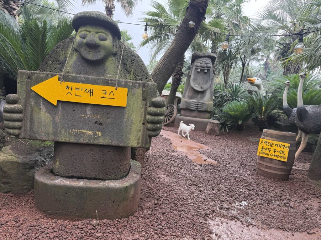A goat and a course sign on the path at Little Prince Tangerine Farm