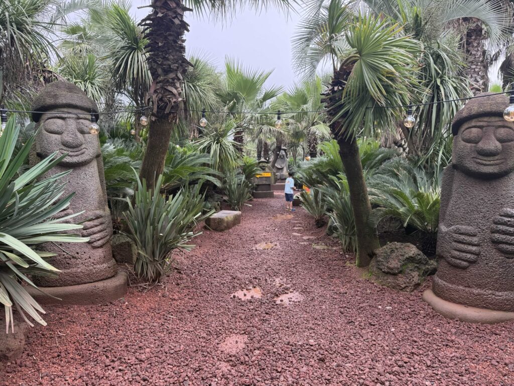 Dol hareubang statues along the path at Little Prince Tangerine Farm