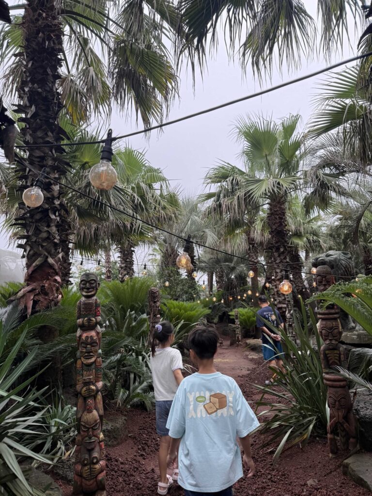 Kids walking the totem-lined trail at Little Prince Tangerine Farm