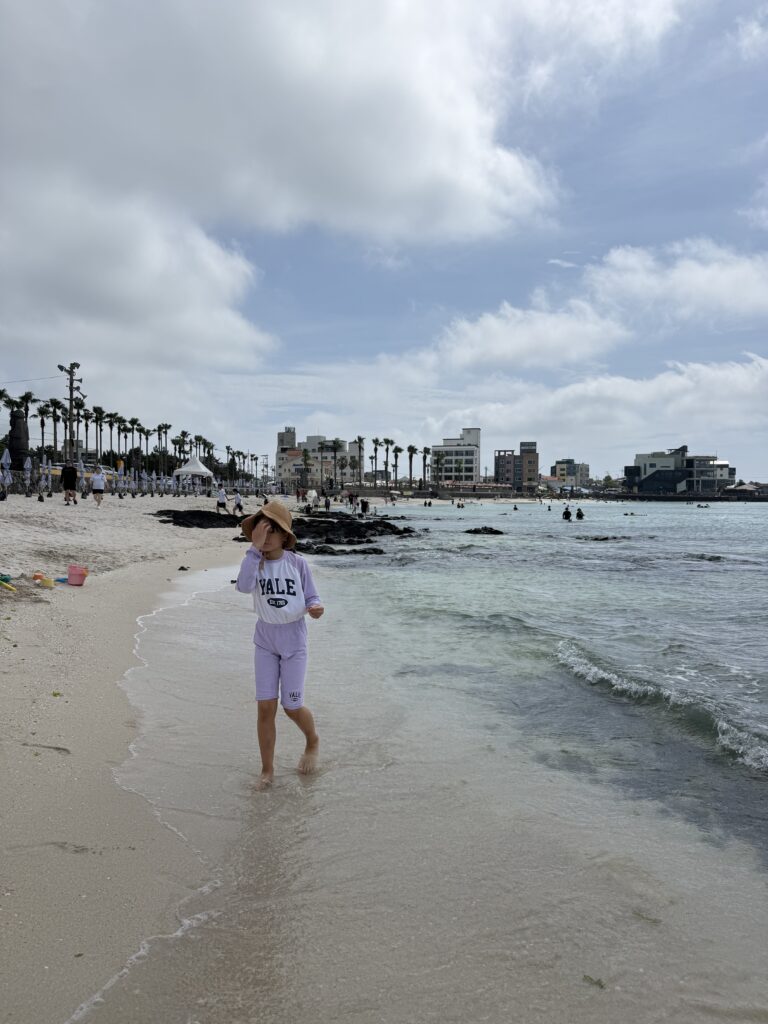 Child at the water's edge at Segial Beach Jeju