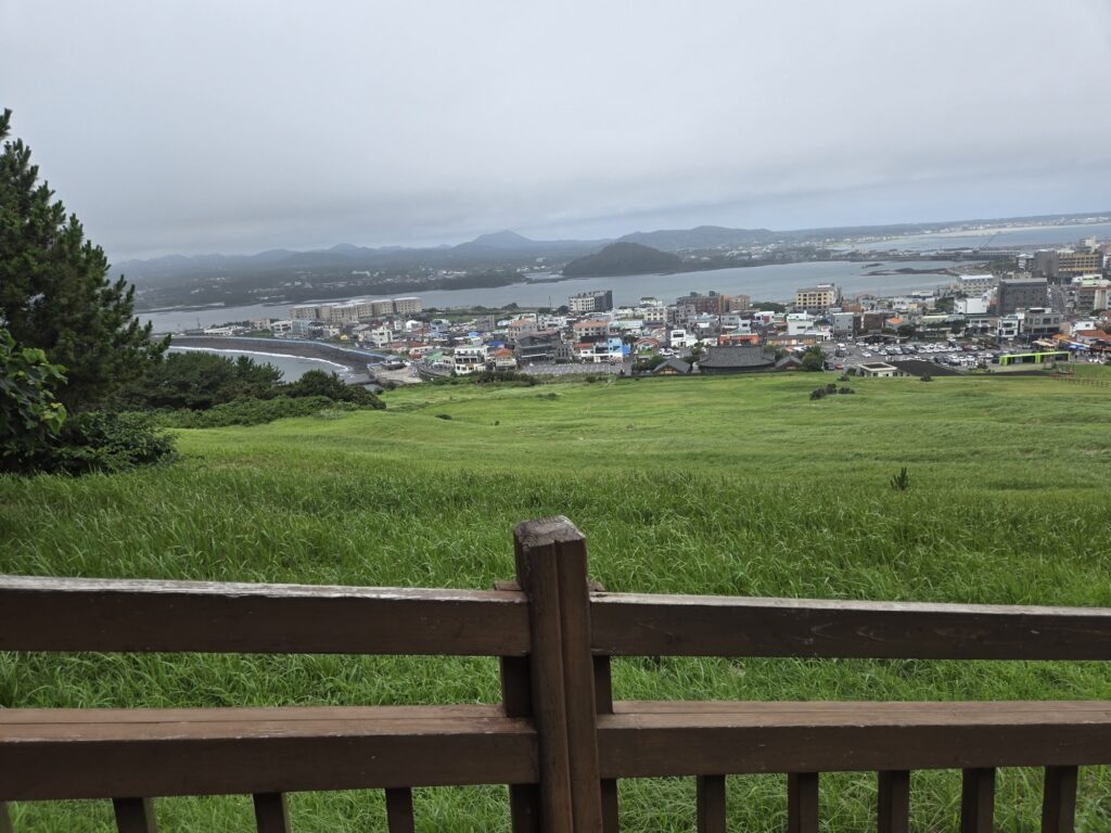 Green crater grassland and Seongsan town from Seongsan Ilchulbong