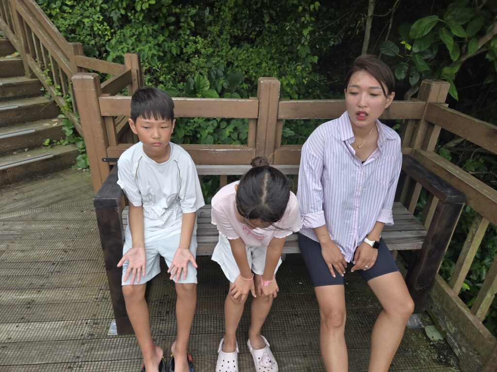 Family catching their breath on the climb up Seongsan Ilchulbong