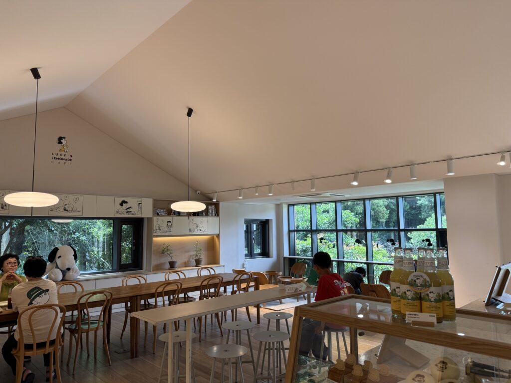 Bright cafe with Snoopy plush and garden windows at Snoopy Garden Jeju