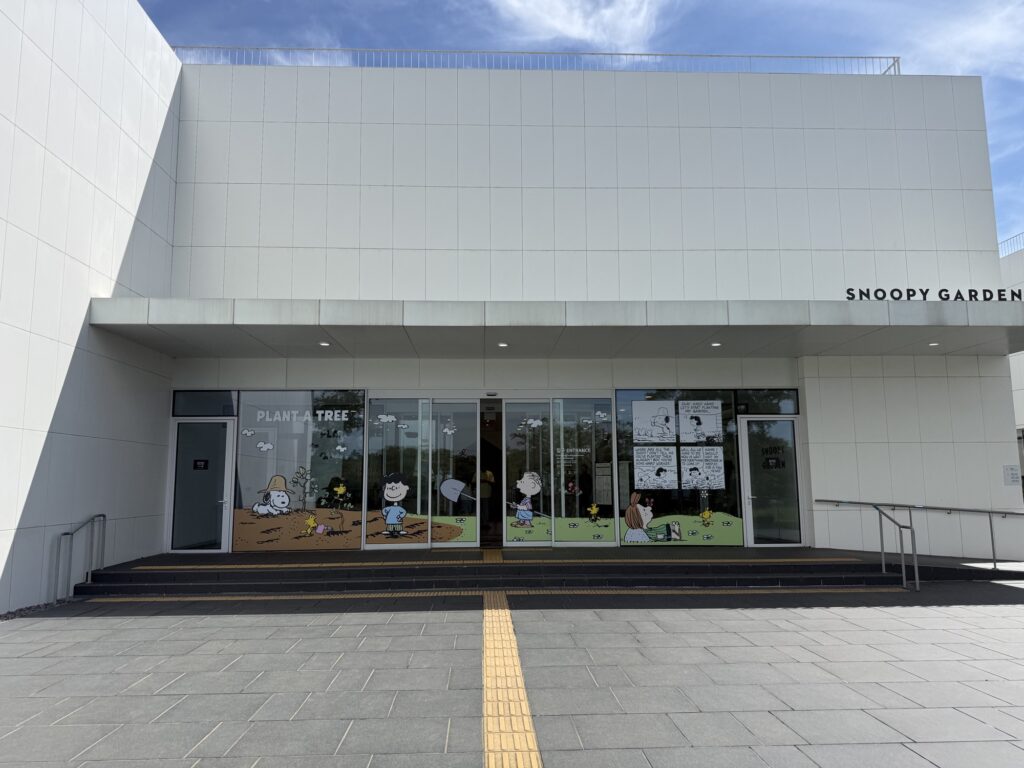 Glass entrance doors of Snoopy Garden Jeju with Peanuts artwork