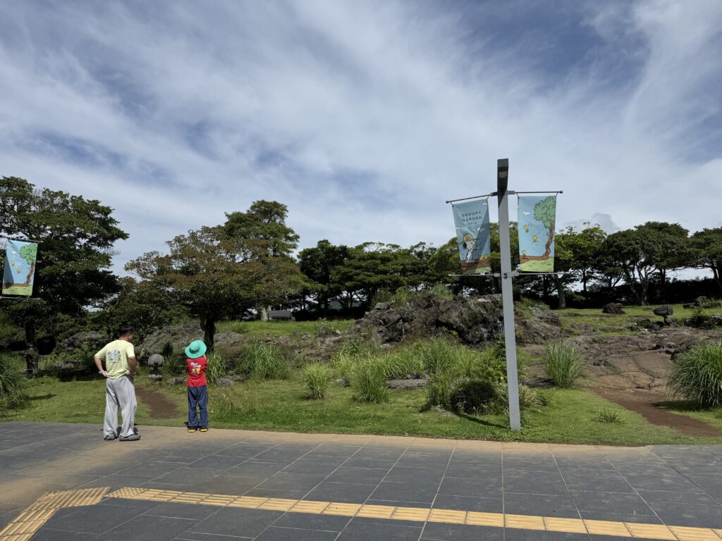 Kids exploring the volcanic-rock garden at Snoopy Garden Jeju