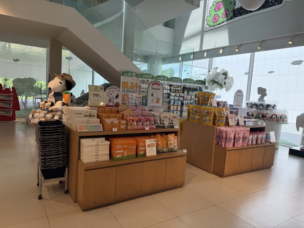 Gift shop with Snoopy plush and snacks at Snoopy Garden Jeju