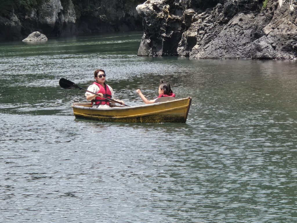 A family boat on the calm green water at Soesokkak