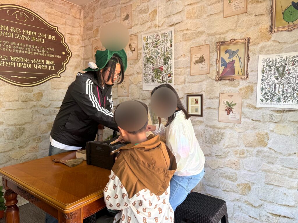 Hands-on experience zone with staff helping kids at Taean Horticultural Therapy Expo