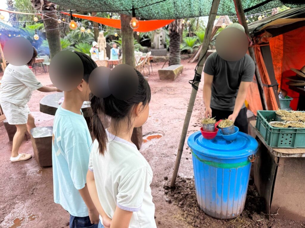 Getting a bowl of animal feed at Little Prince Tangerine Farm