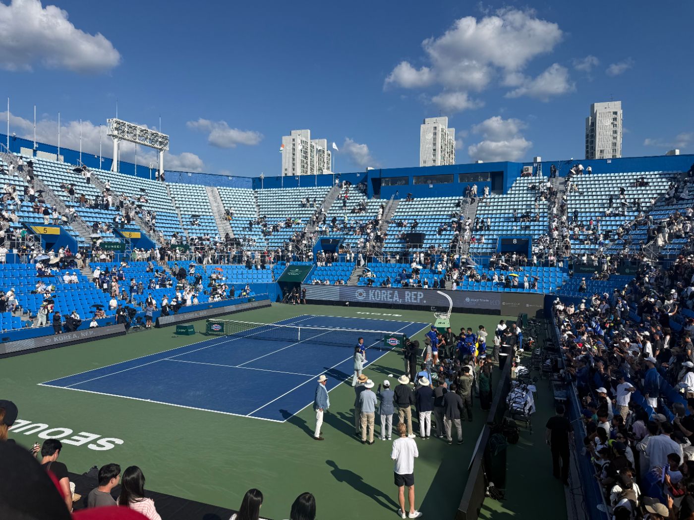 Officials and team members gathered on court for the post-match interview