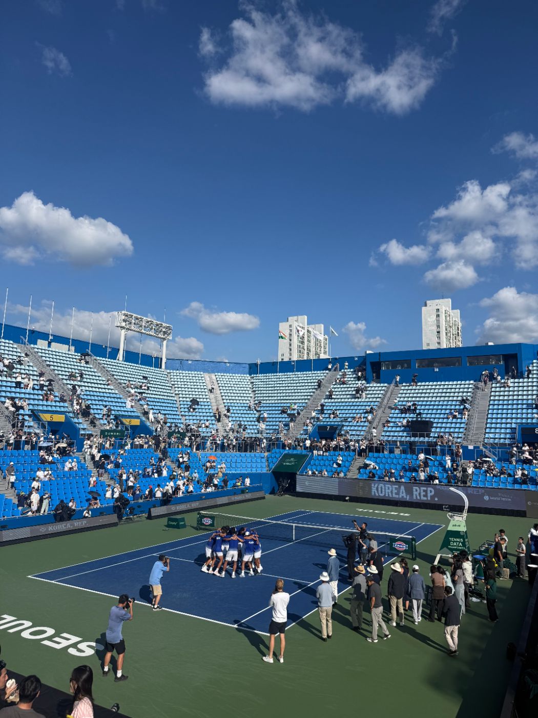 Korean players in a huddle on the court after the final match