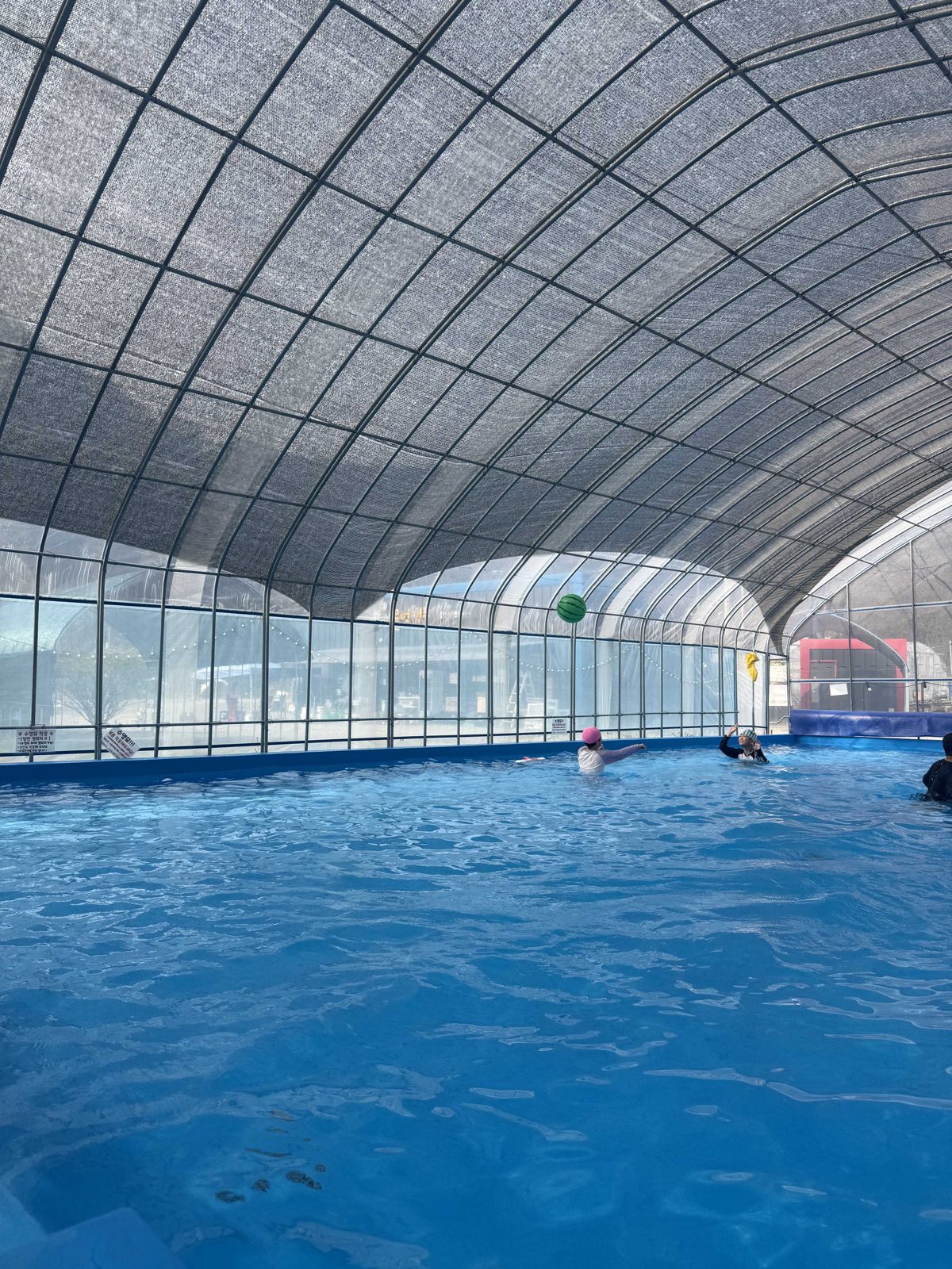 The covered heated pool under a vinyl dome