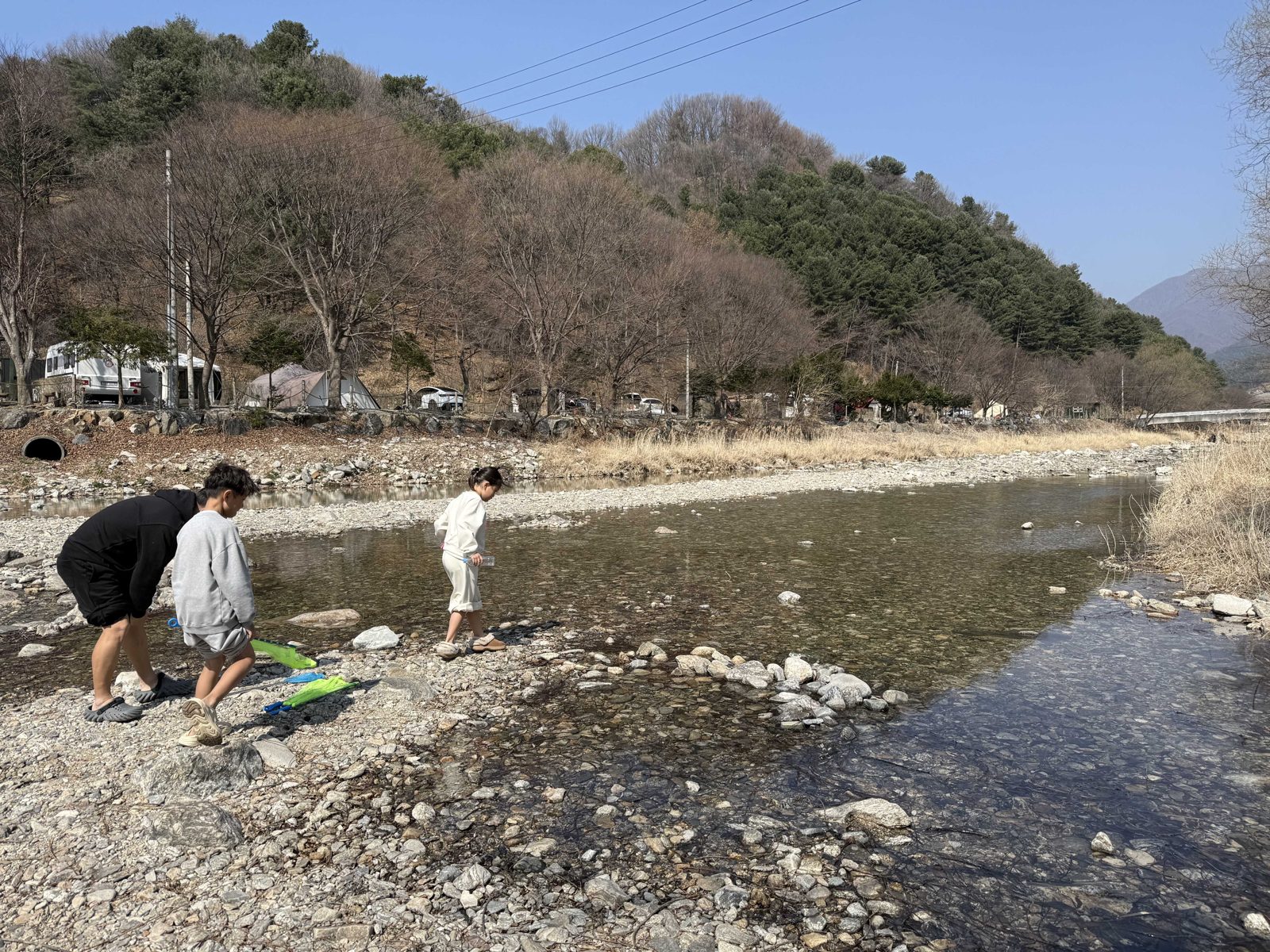 Our kids walking into the shallow stream